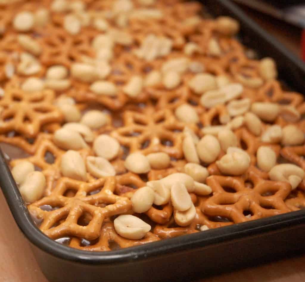 Pretzel and Peanuts on a layer of chocolate in a tray