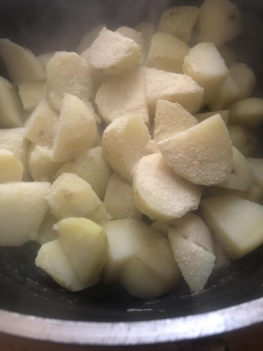 Boiled potatoes in pot with semolina