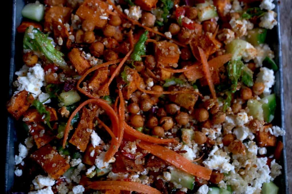 Chickpea,sweet potato, feta and quinoa salad in a square plate on table