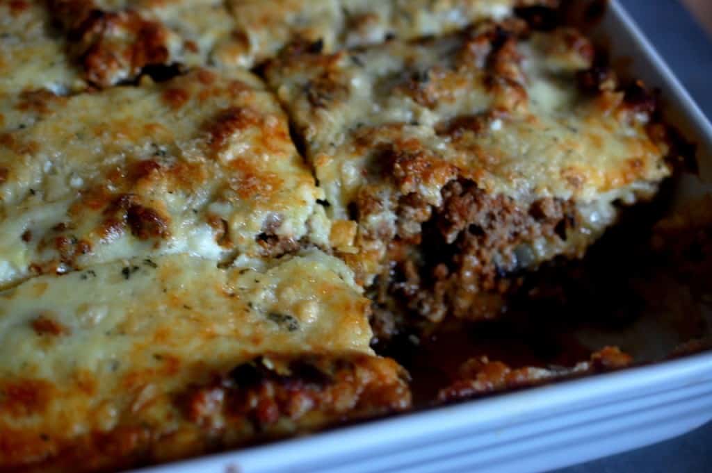 Moussaka in a square dish cut into slices
