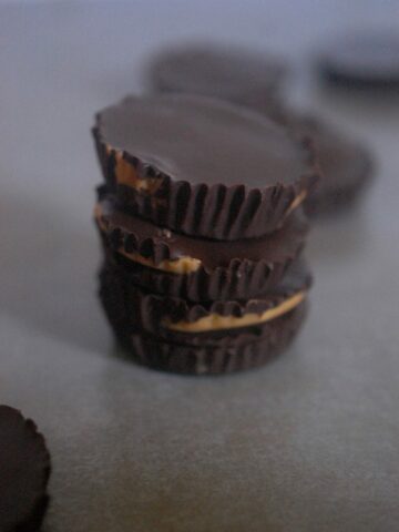 Chocolate Peanut butter cups pile on grey background