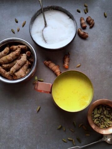 Three bowls with ingredients and one cup of turmeric tea