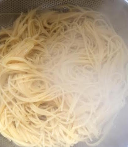 Spaghetti draining in colander