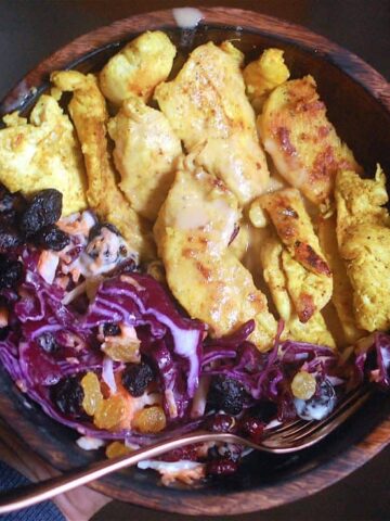 chicken satay salad and cabbage salad in wooden bowl