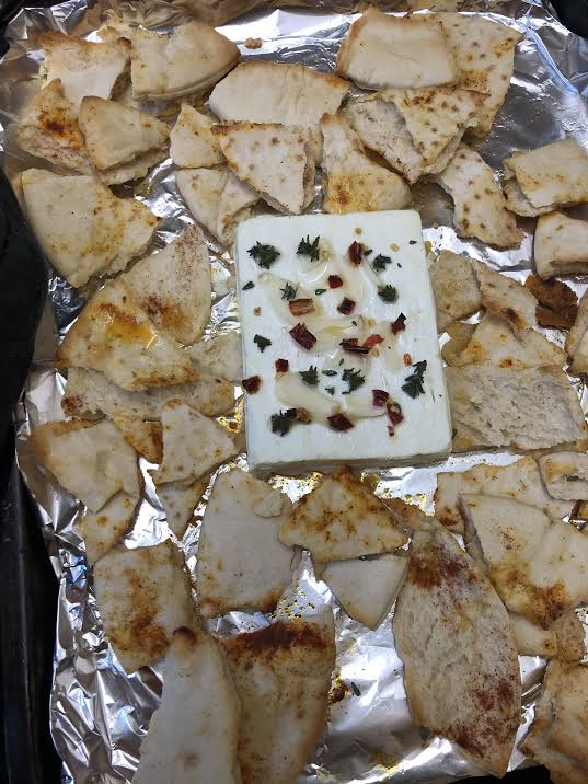 Baked feta and pitta on a tray 
