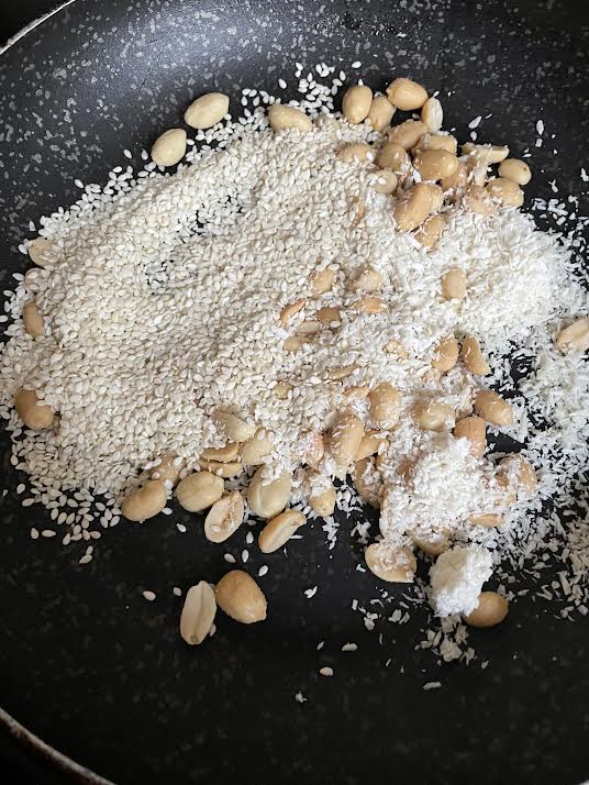 Peanuts, sesame and coconut in a pan
