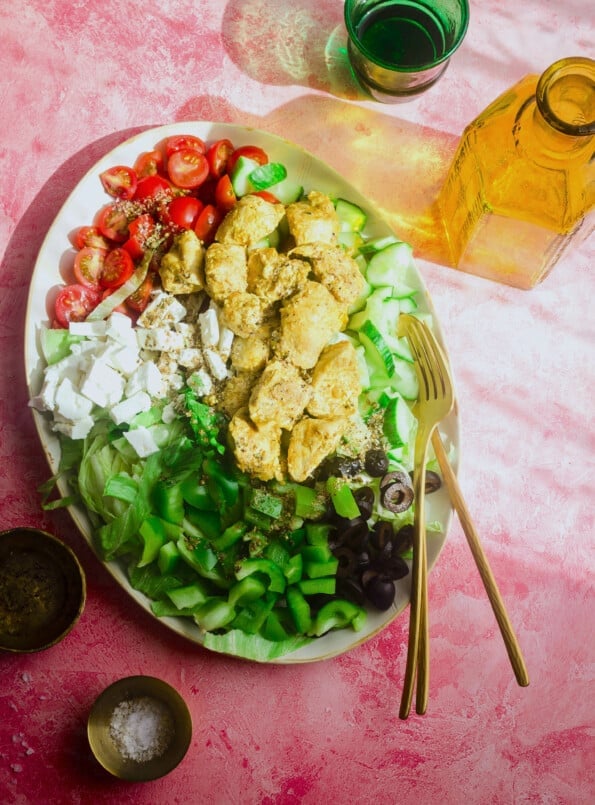 Greek Chicken salad on a platter with forks 