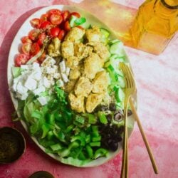 Greek Chicken salad on a platter with forks
