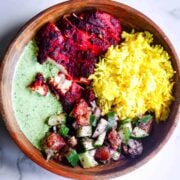 Tandoori, rice, mint sauce and salad in bowl