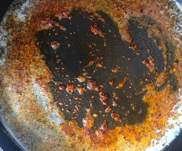 Butter and chilli flakes sizzling in pan