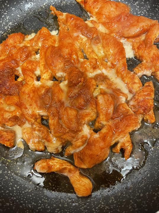 Chicken cooking in pan