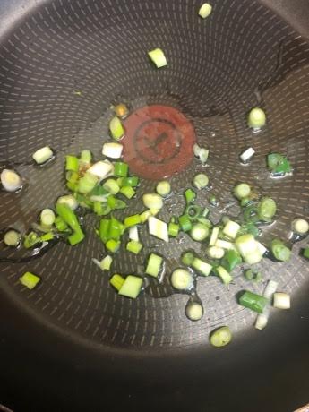 Spring Onions and oil in pan