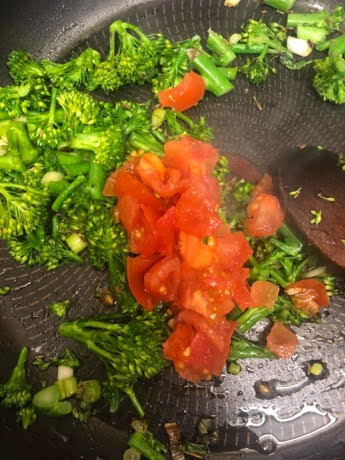 Broccoli and tomato in pan