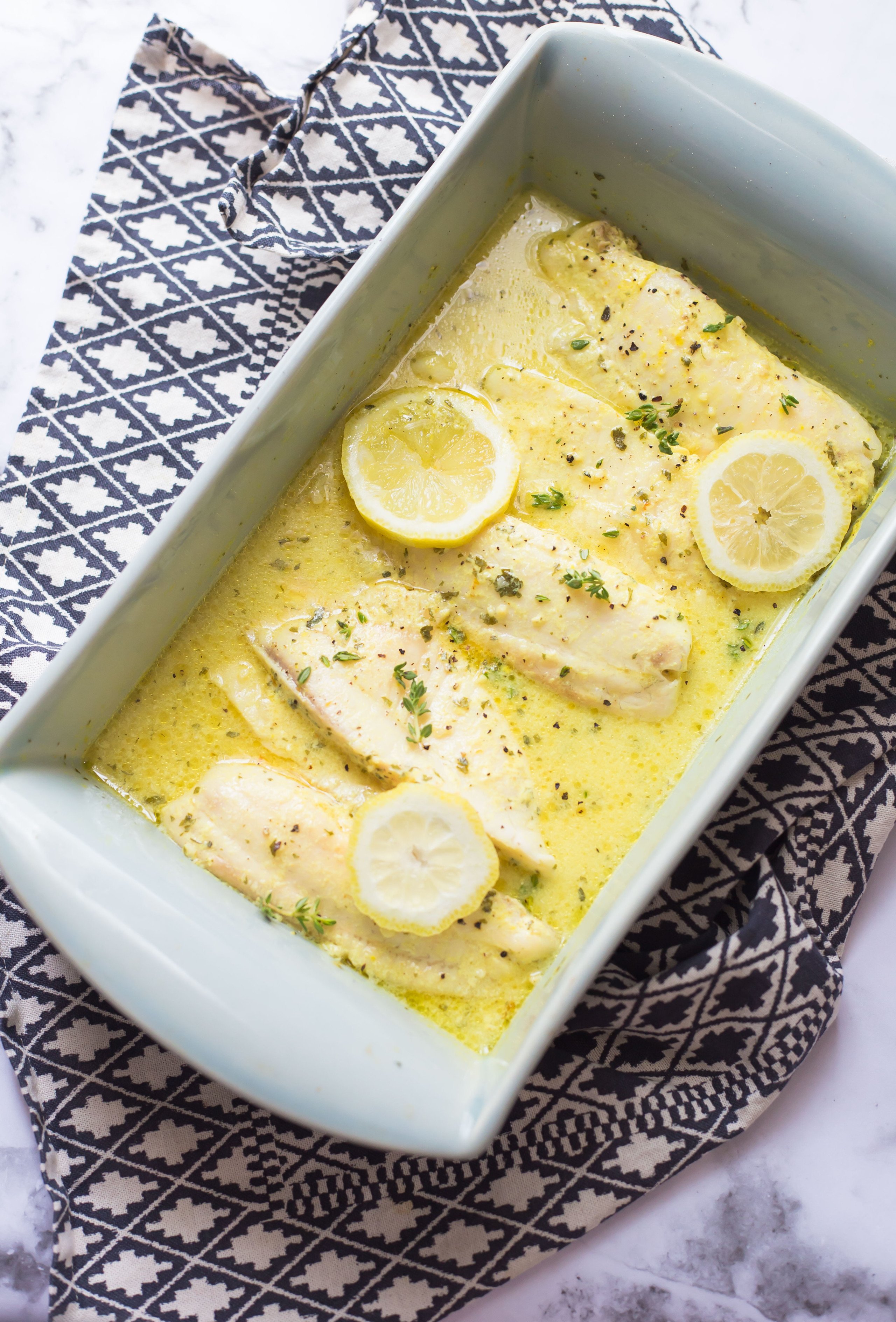 Fish fillets in a lemon and mustard sauce in a casserole dish