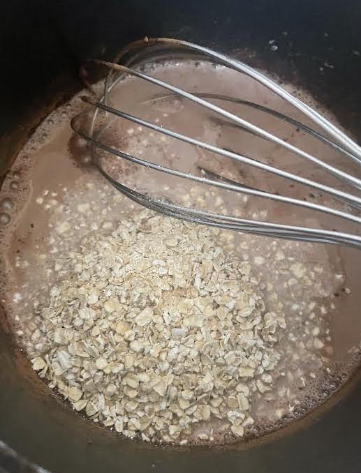 Oats added to pot on stove