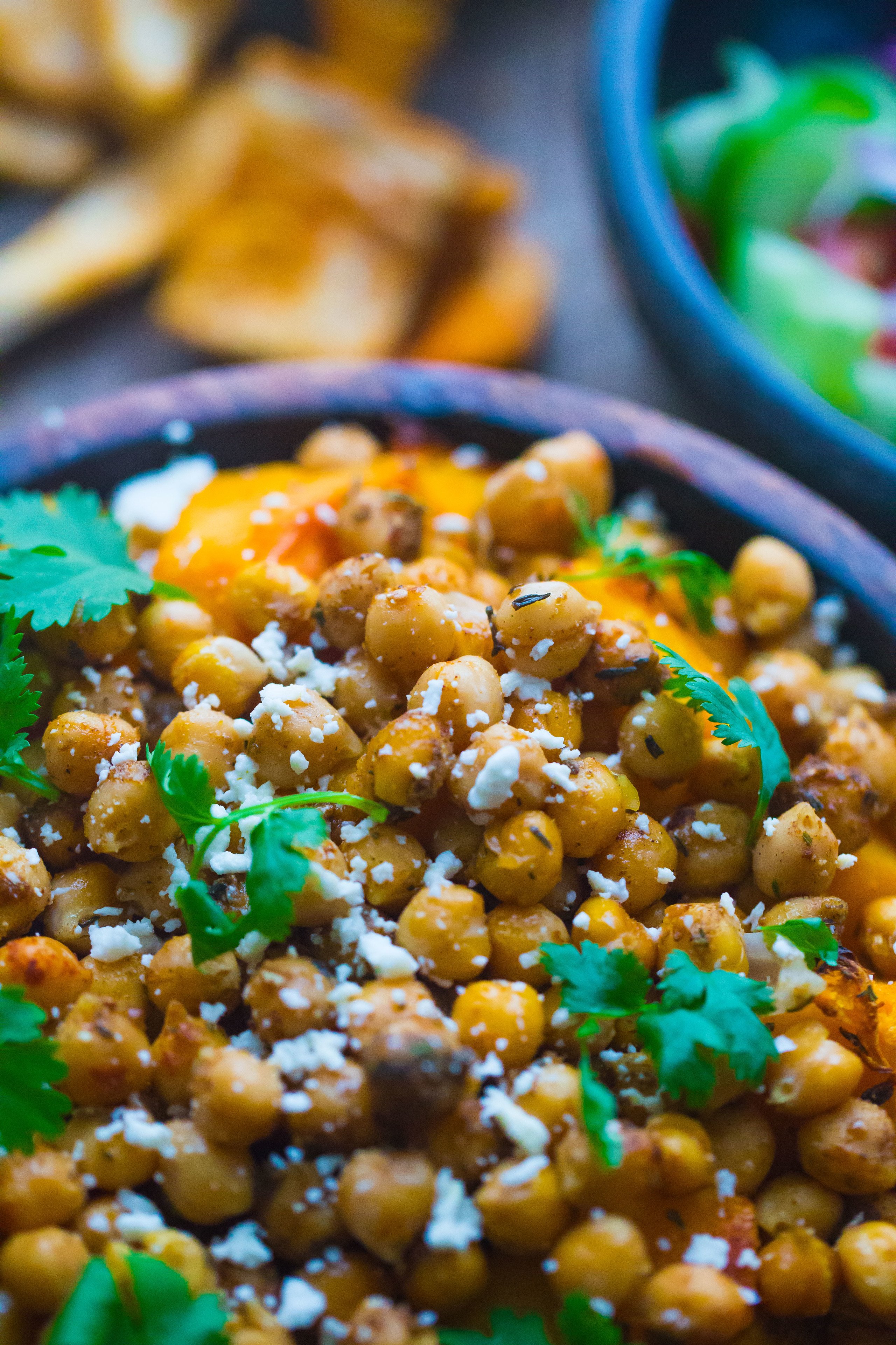 Butternut Squash and Chickpea Salad with feta and coriander in wooden bowl