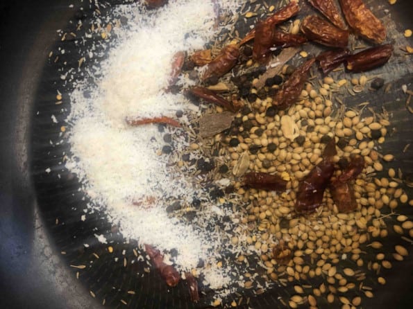 Dry spices and coconut in a dry pan