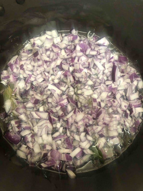 Onions added to oil in pot