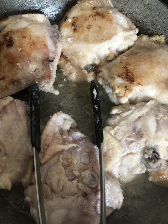 Chicken browning in pan