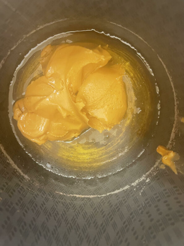 Peanut butter added to golden syrup in pot