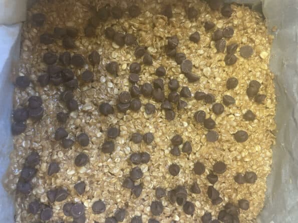 Chocolate Chips added to Oat mixture in tin