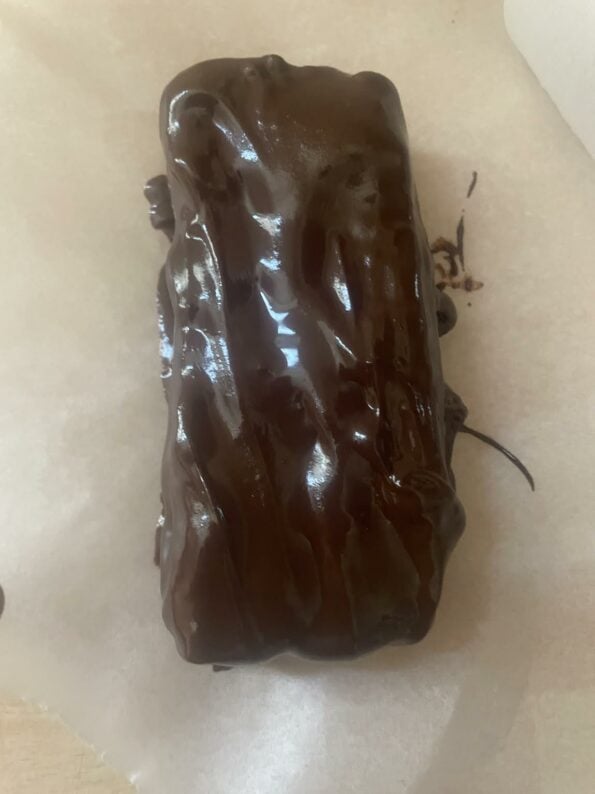 Date Bars covered in chocoalte on baking paper
