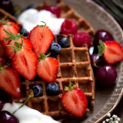 Waffles with fresh berries and yoghurt on plate