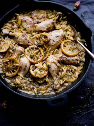 One Pot Lemon Chicken and Thyme Orzo with lemons on top and spoon