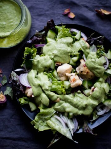 Indian Chicken Salad with Avocado Green Chutney Dressing on black plate