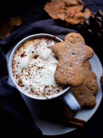 Copycat Gingerbread Latte in a cup with gingerbread on cup
