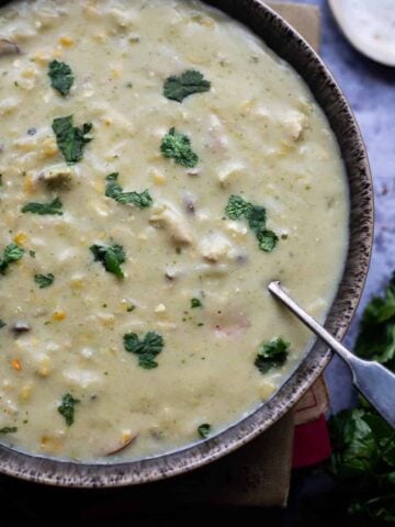Chicken, corn and orzo soup in bowl
