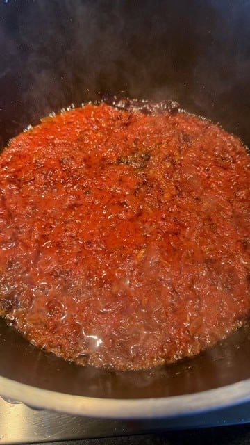 Chicken Akni - The BEST One Pot Chicken and Rice Pilau Cooked tomatoes in pot