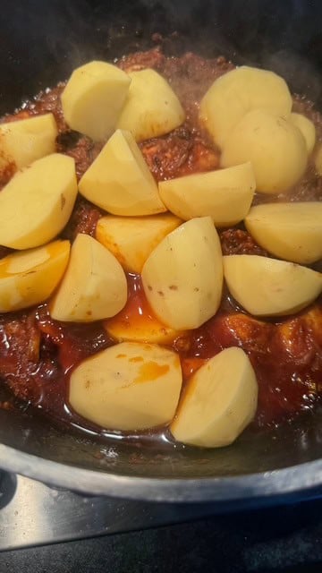 Chicken Akni - The BEST One Pot Chicken and Rice Pilau Potatoes added to pot