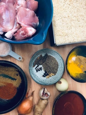 Ingredients for Chicken Akni on a table