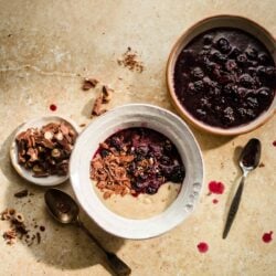 Talbina in a bowl with chocolate and stewed blueberries to side