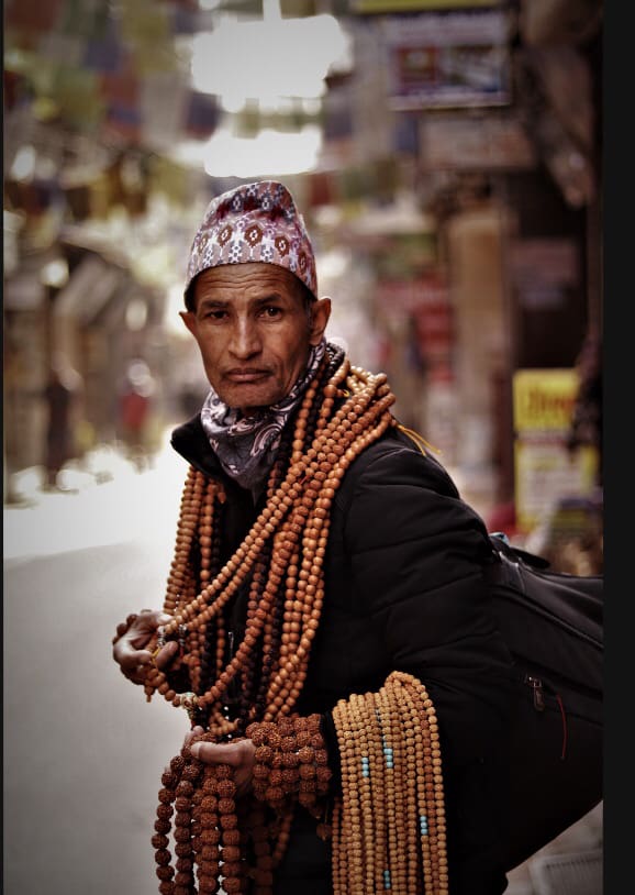 Muslim Man with mosque hat carrying multiple tasbeehs/rosary