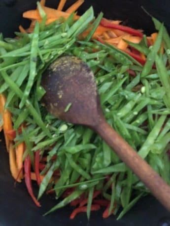 Green Beans and veg in pot with wooden spoon