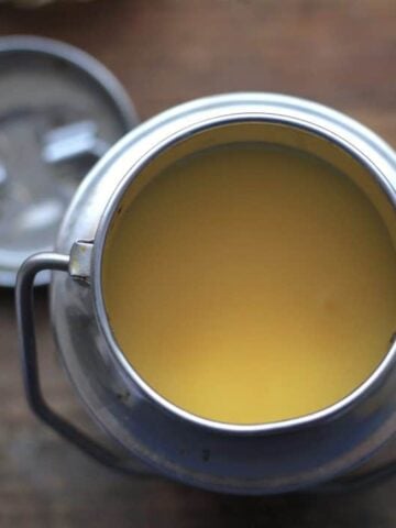 Solid ghee in traditional silver indian pot