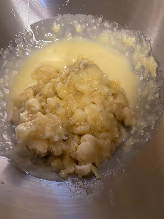 Mashed Bananas added to batter in bowl of stand mixer