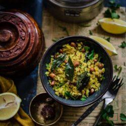 Poha in a bowl with Nuts and curry leaves