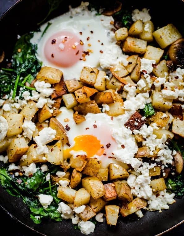 Egg, Potato cubes, spinach and mushrooms in pan 