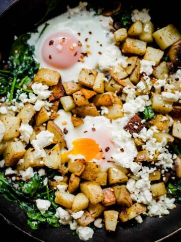 Egg, Potato cubes, spinach and mushrooms in pan