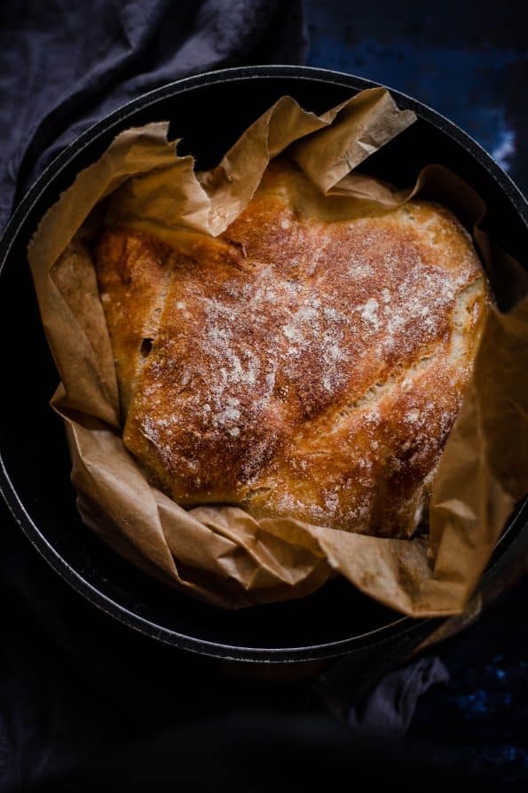Baked bread in a cast iron pot with baking paper