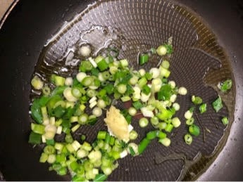 Spring onions and garlic in pan