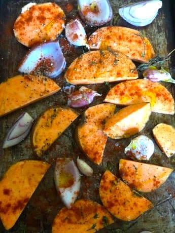 Sweet potatoes, red onions and garlic n oven tray with paprika and oil
