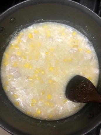 Chicken and sweetcorn cooking in pot