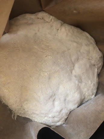 Lightly floured dough in baking paper
