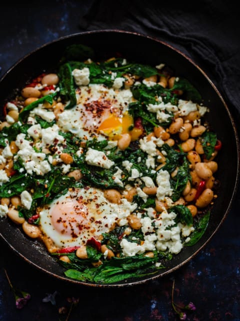 Eggs, Spinach, Butterbeans and Peppers in a dark pan
