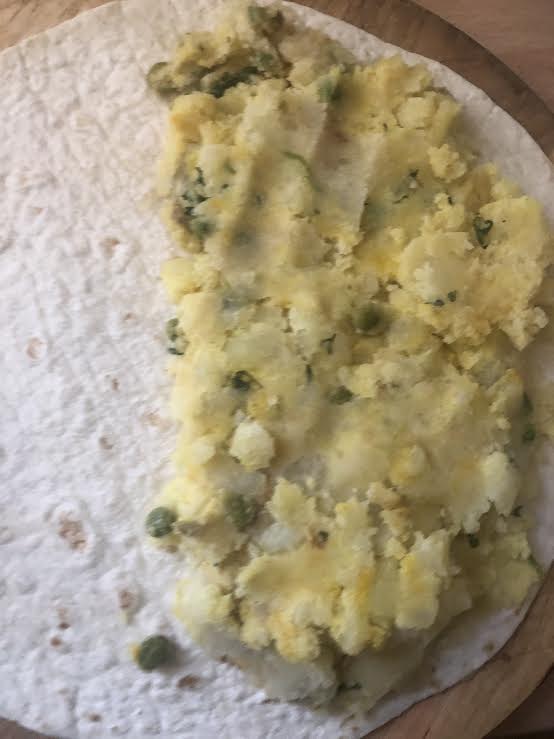 Potato and pea mixture spread on half wrap