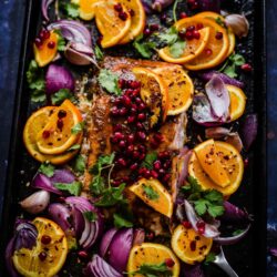 Pomegranate and Orange salmon with red onions in tray